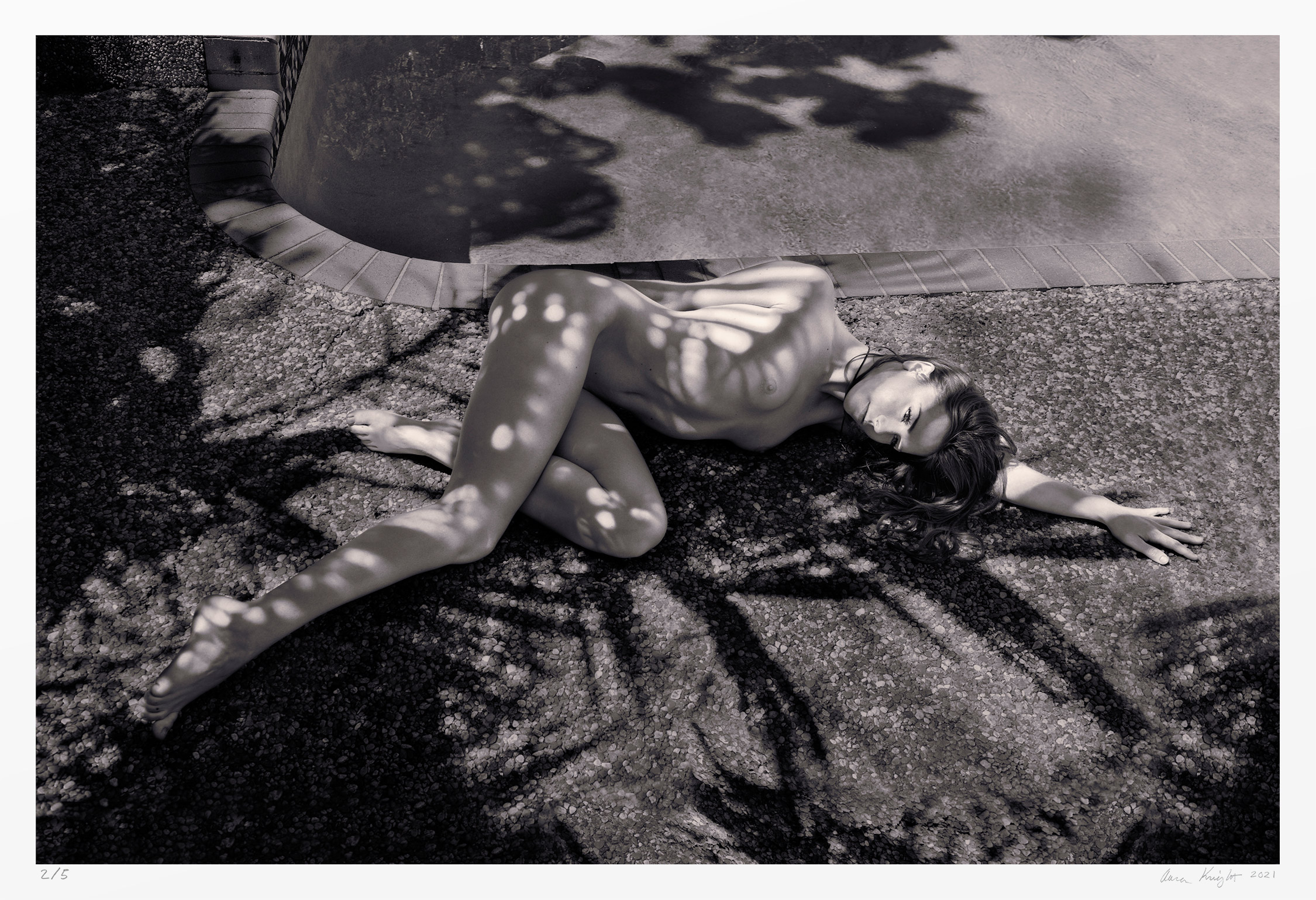 Black and white figure photography: nude woman, poolside & shade